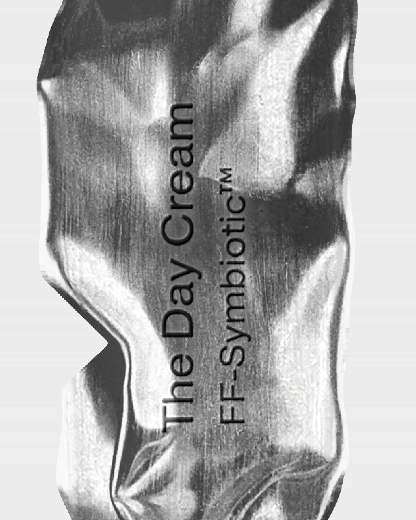 The Day Cream typography applied to a reflective silver packaging surface.