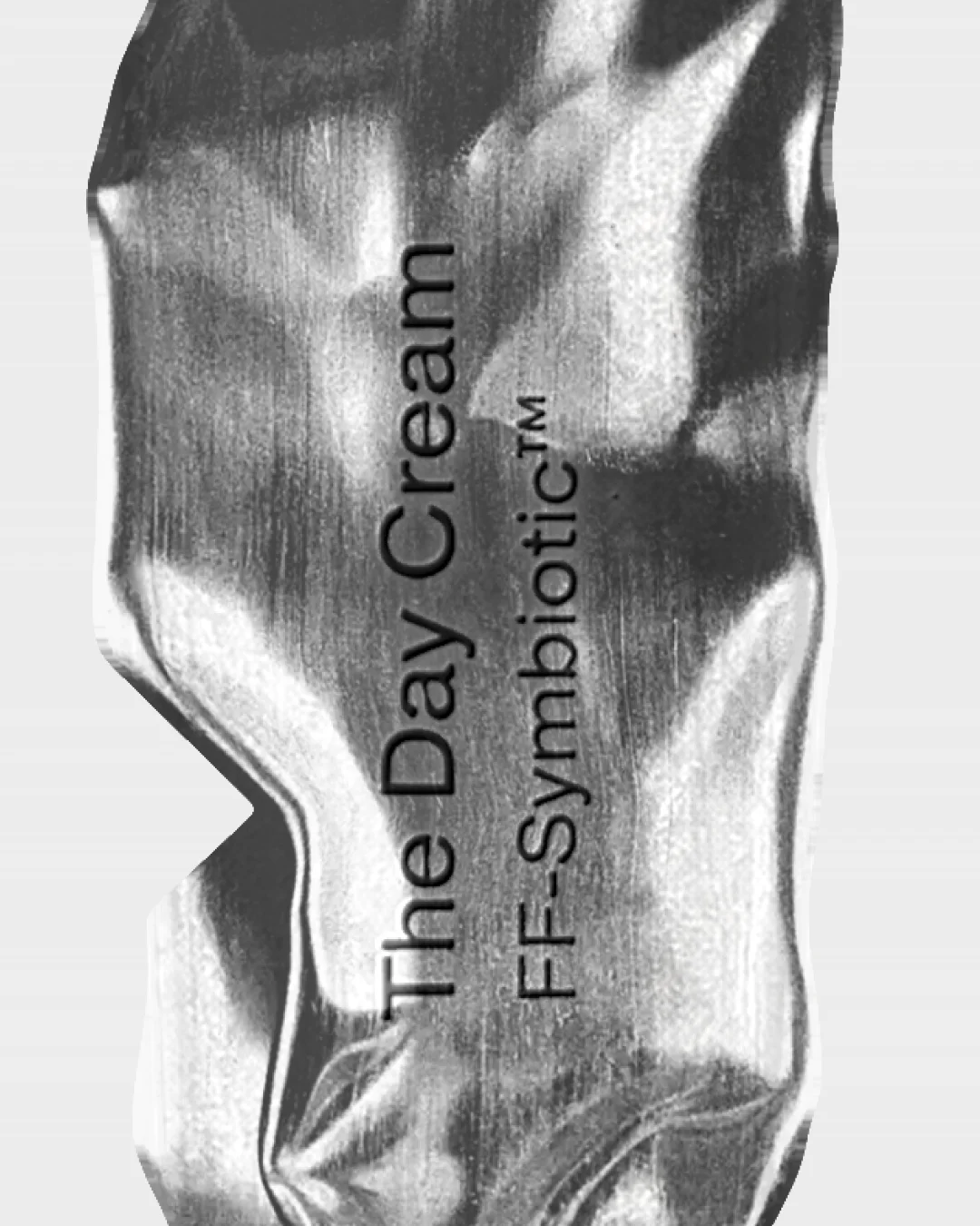The Day Cream typography applied to a reflective silver packaging surface.