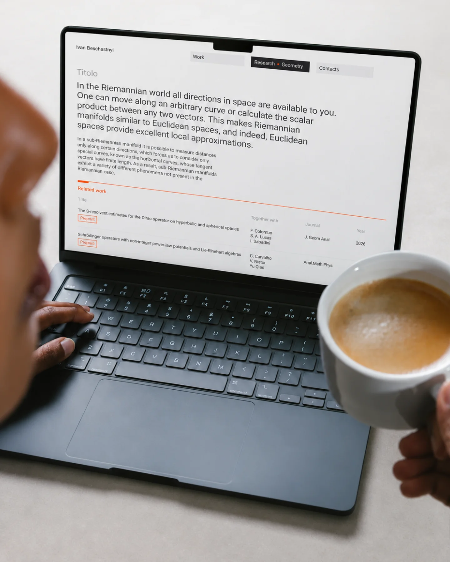 Ivan Beschastnyi’s website displayed on a laptop beside a cup of coffee.